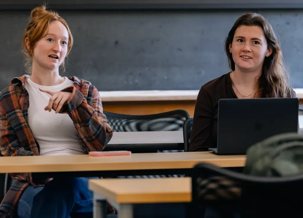 Two M S W students talk in a classroom