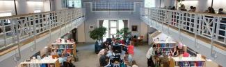 A view from the catwalk in the Portland campus library of students studying in the library